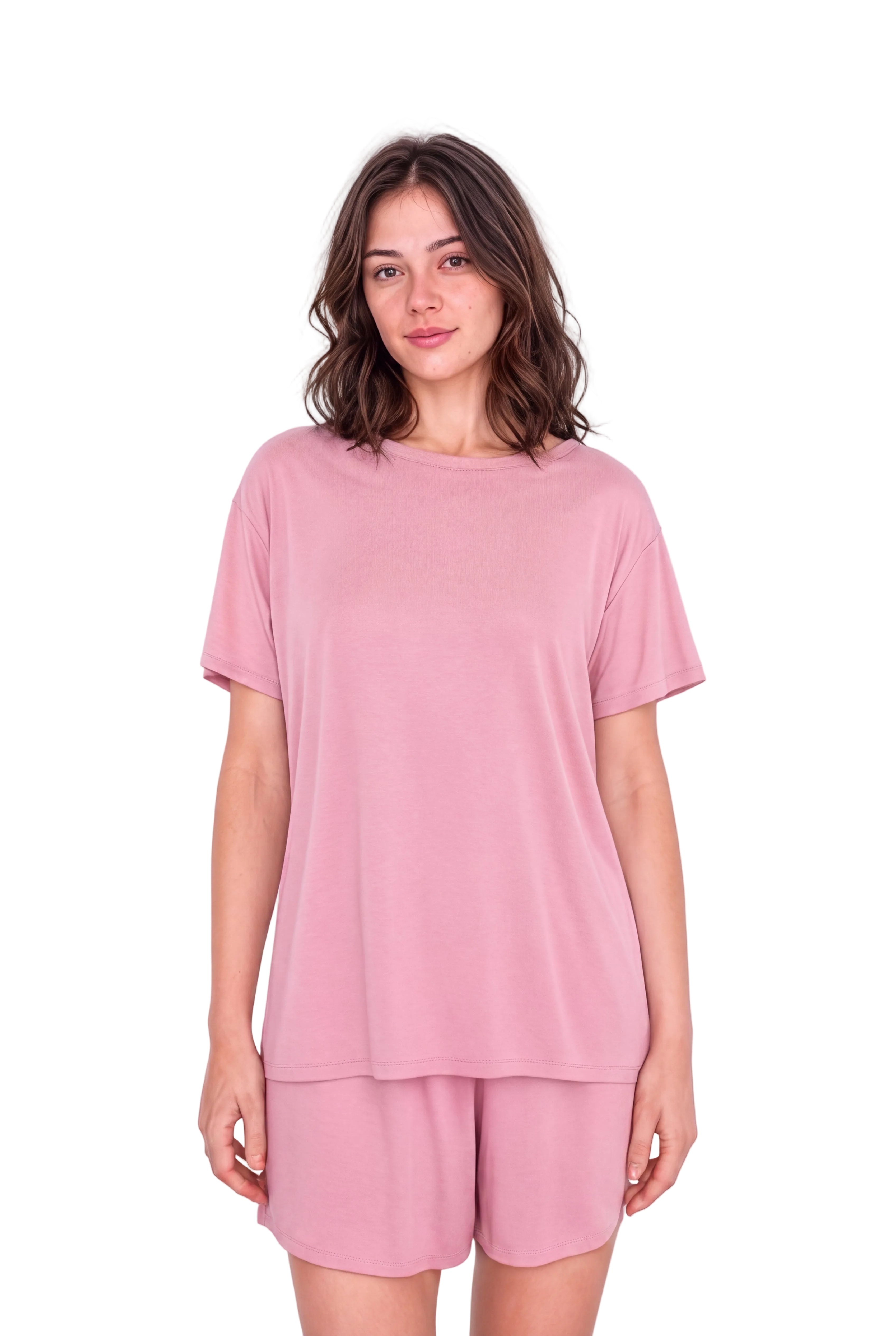 A woman modeling a dusty pink short-sleeve t-shirt and matching lounge shorts against a plain light background.