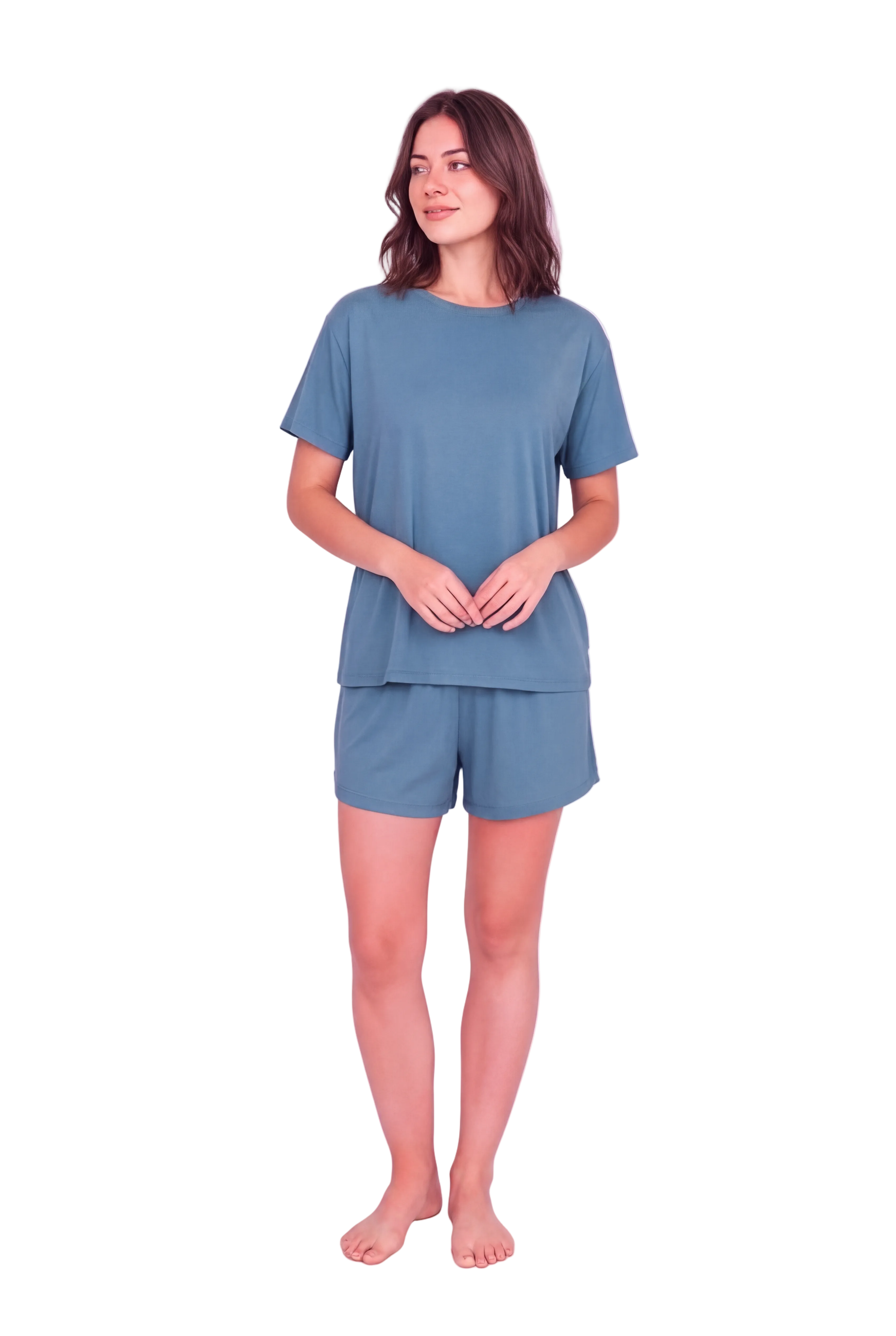 A woman modeling a matching two-piece loungewear set consisting of a short-sleeve crewneck t-shirt and matching shorts in a dusty slate blue color, set against a solid pale pink studio background.