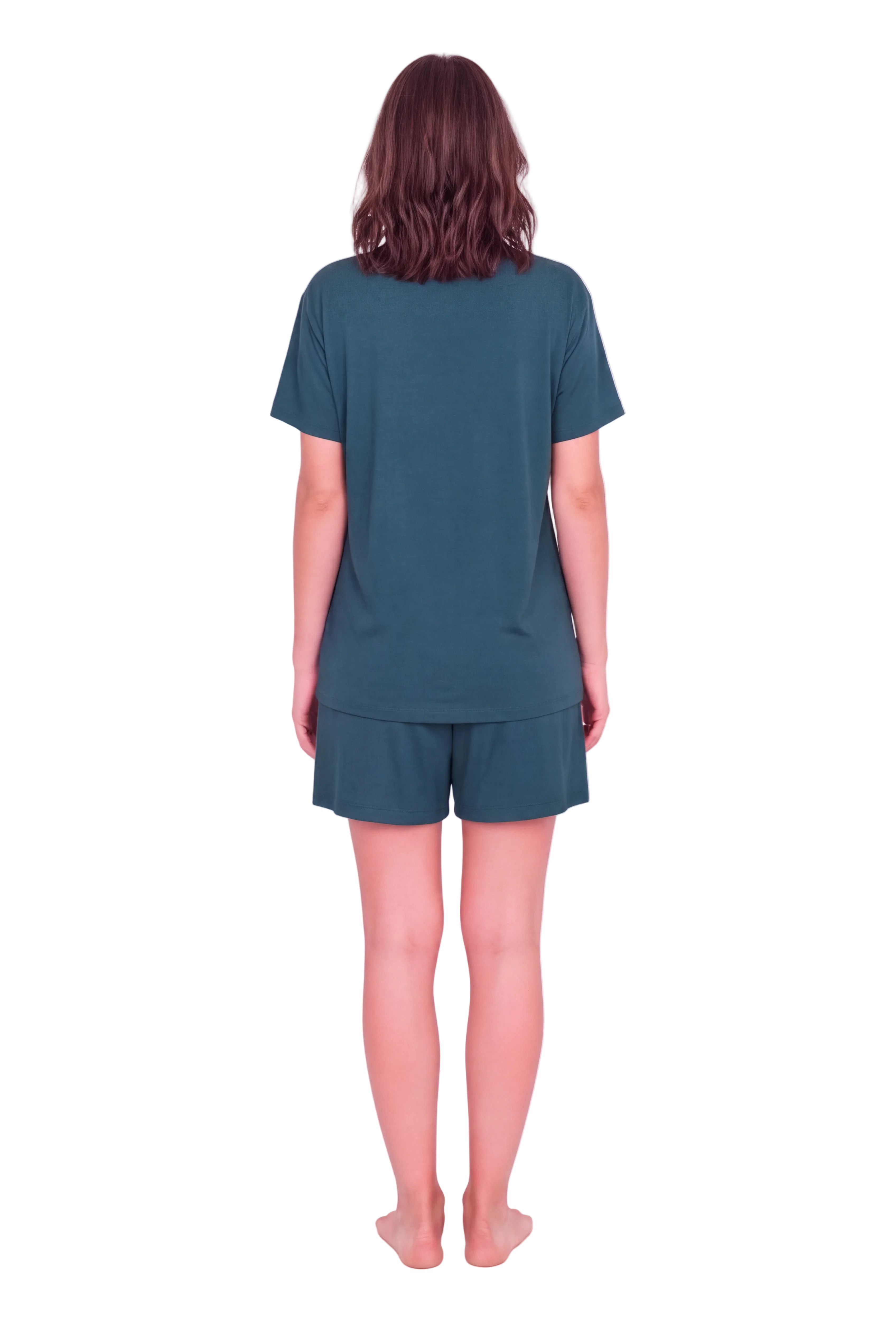 A woman viewed from behind wearing a matching dark teal short-sleeve t-shirt and shorts set against a solid pale pink studio background.