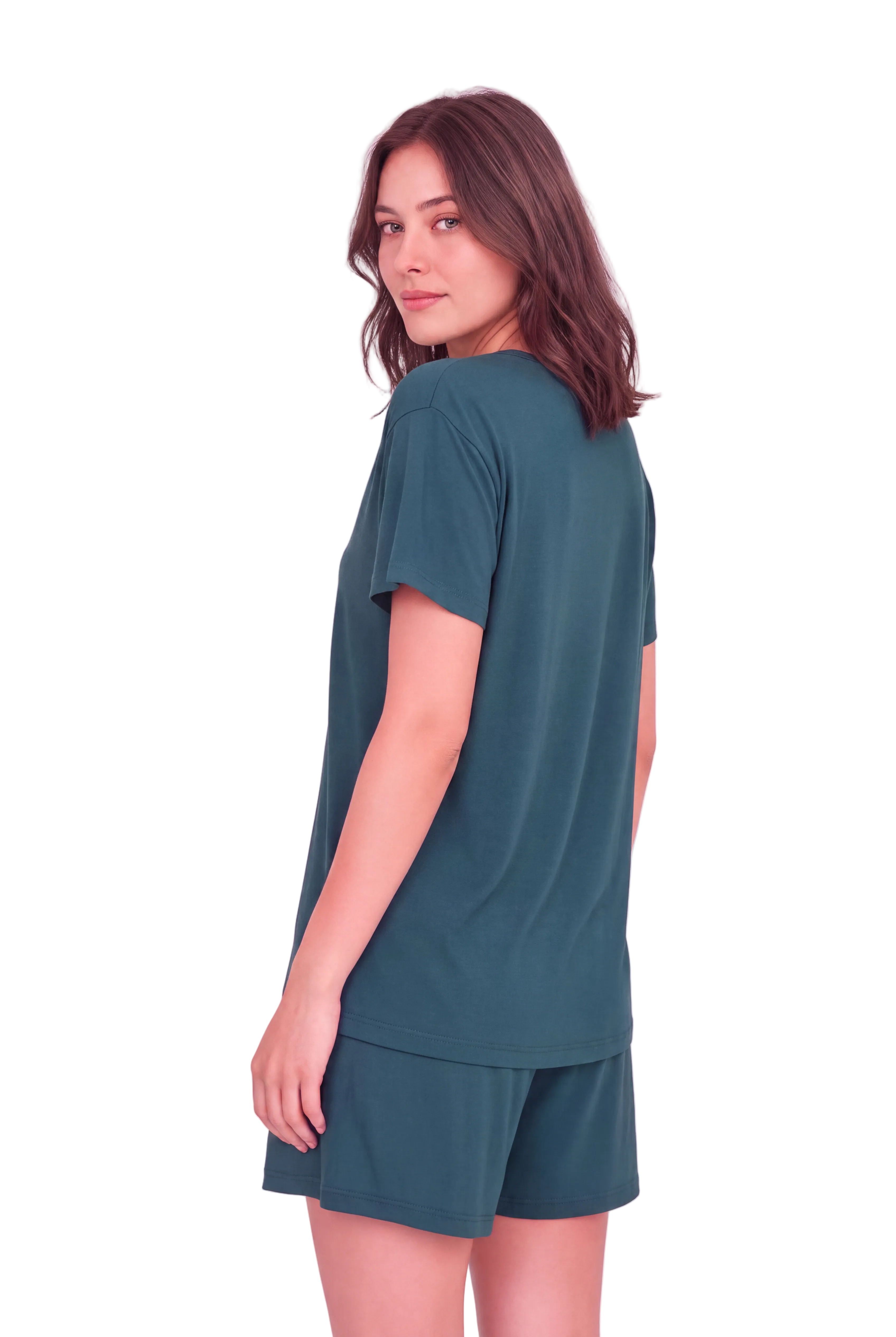A woman wearing a matching dark teal lounge set consisting of a short-sleeve t-shirt and shorts, shown from a three-quarters back view against a solid pale pink background.