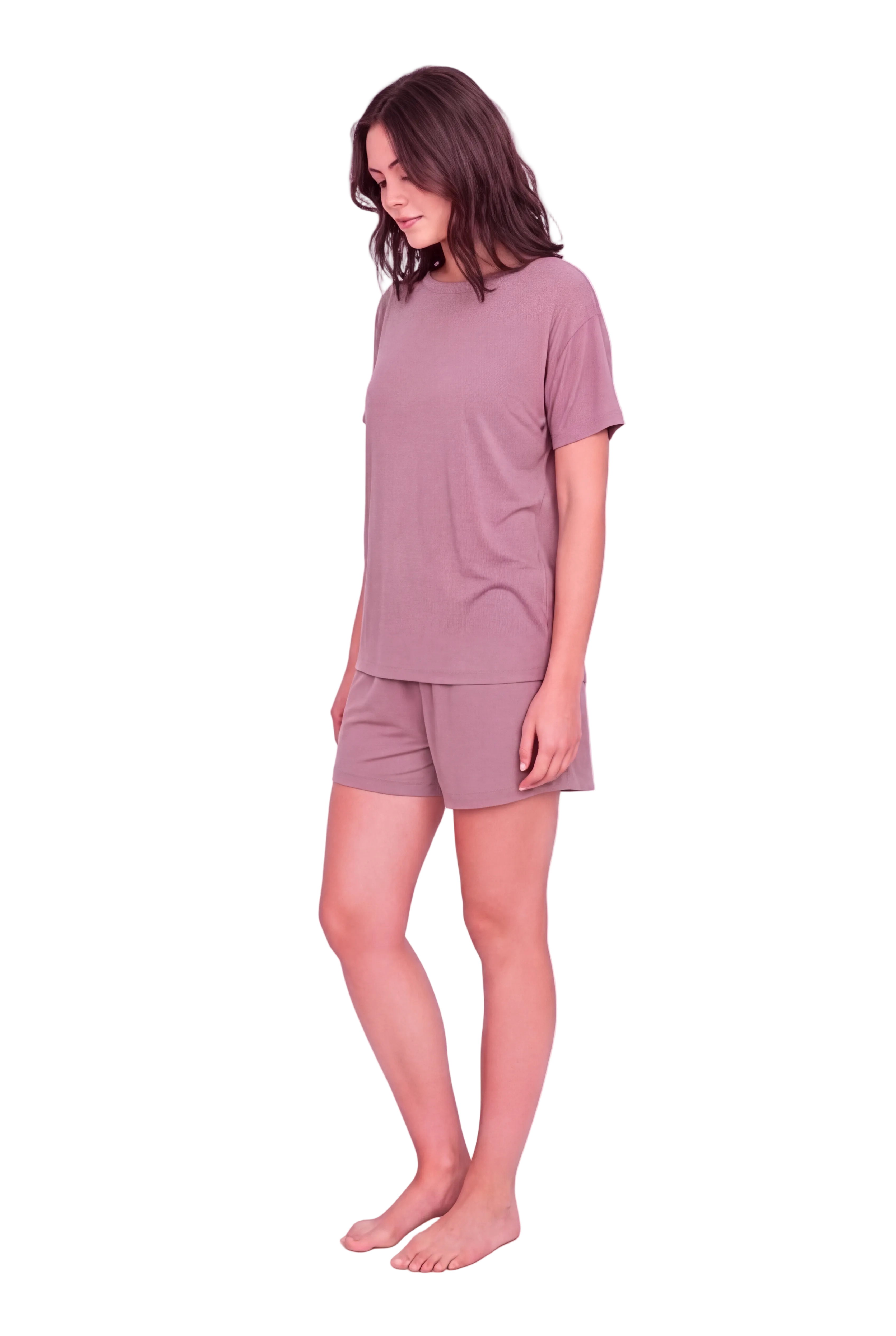 A woman modeling a matching mauve short-sleeve t-shirt and shorts set against a solid pale pink studio background.